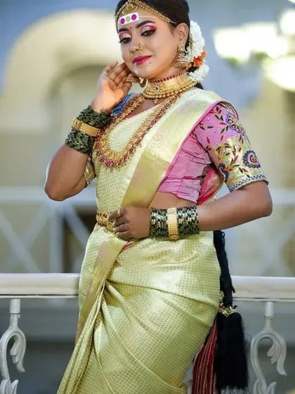 A full-length view of a bride, showcasing the elegance of the saree and the grandeur of our complete temple jewellery set.