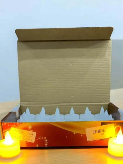 A box of LED tea light candles, ready for distribution or personal use. They are a great gifting option for Diwali, providing a safe alternative to traditional diyas.