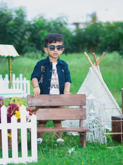 This little guy is looking very stylish for his outdoor photoshoot, posing confidently in his sunglasses.