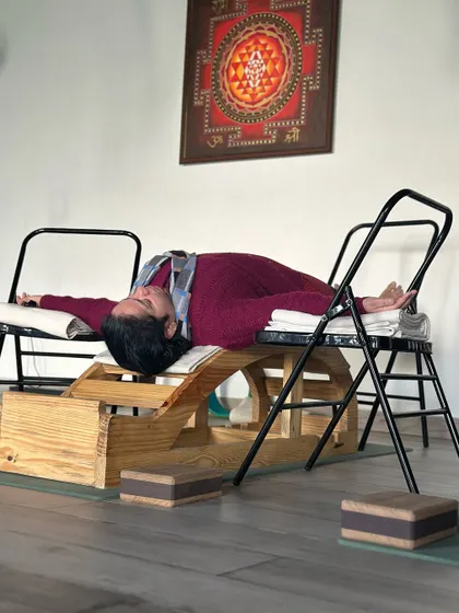 This supported backbend on a specialized bench is designed for deep relaxation and spinal release. It opens the chest and allows the nervous system to calm down, making it a powerful therapeutic tool for both physical and mental stress.