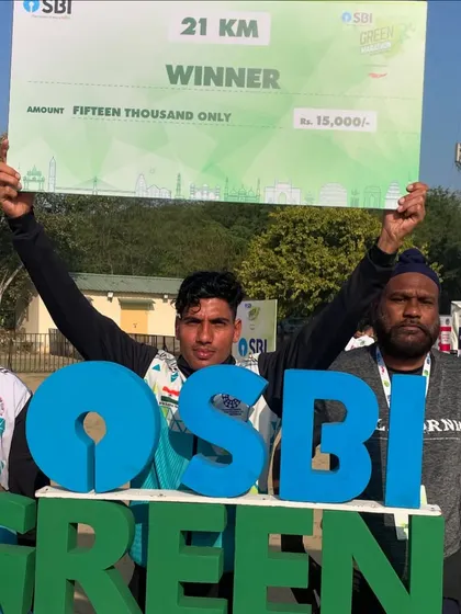 A 21km winner from my team proudly holding his prize cheque at the SBI Green Marathon. This is what victory looks like.