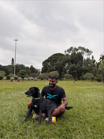 Sitting on the grass with Batman in Cubbon Park. He's more than a pet; he's family.