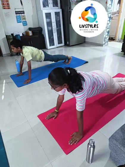 Two young clients hold a strong plank pose, a fundamental exercise for building core strength and stability.