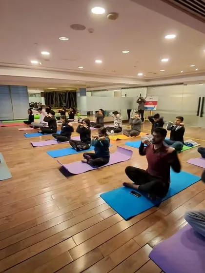 Guiding employees through a pranayama exercise during a corporate wellness session. These simple techniques can greatly reduce stress.