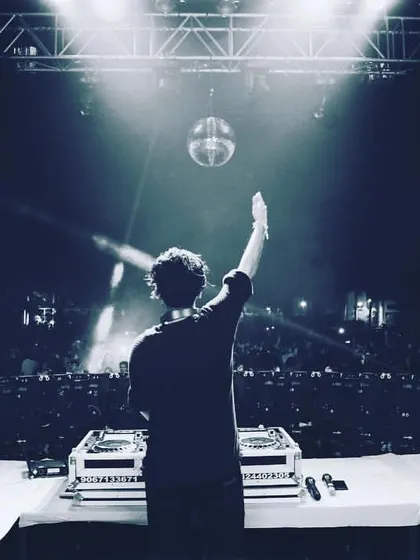 A solo moment on a huge stage, reaching out to the crowd under a disco ball. This was a lit night in Vadodara to kick off the new year.