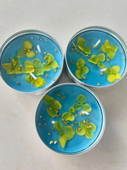 A set of three travel tin candles with beautiful pressed green hydrangeas.