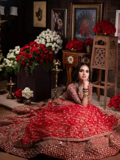 Another stunning shot of this bride in her red lehenga, showcasing the incredible detail of the outfit and the flawless, radiant makeup.