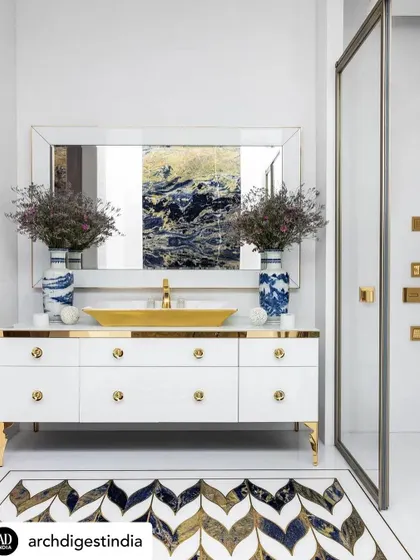We used Lapis Lazuli, brass, and white marble to give this bathroom a truly luxurious feel. The custom vanity features a gold-toned sink and hardware, while the floor has a striking chevron inlay that ties the whole design together.
