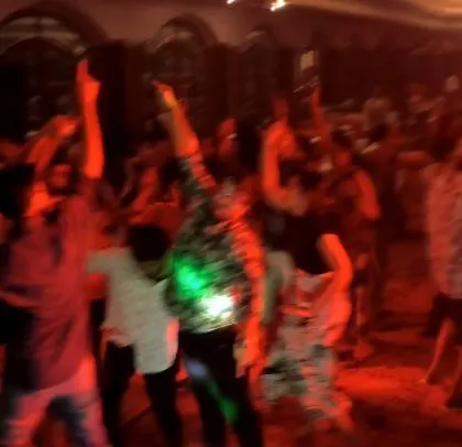 Red lighting creates a high-energy mood at the pediatricians' conference party.