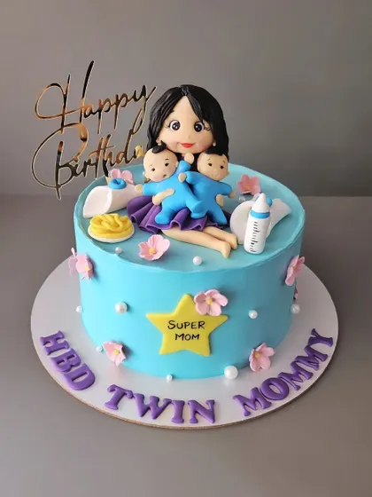 A birthday cake for a twin mommy. This chocolate truffle cake celebrates a supermom with her two little boys.