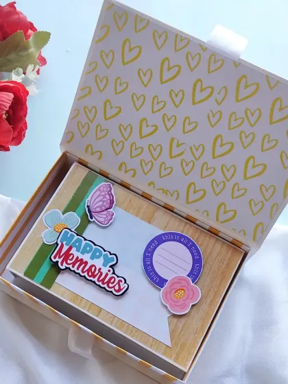 Preserving happy memories is what I love to do. This scrapbook, with its cheerful yellow heart-patterned box, was made to celebrate an anniversary.