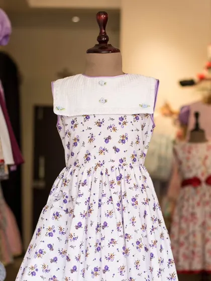 Another view of the purple floral dress with the classic sailor collar, displayed in my boutique.