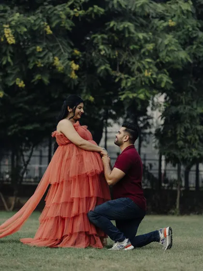 A romantic proposal moment during a maternity shoot. Our flowing gown adds to the fairytale-like atmosphere of this beautiful picture.
