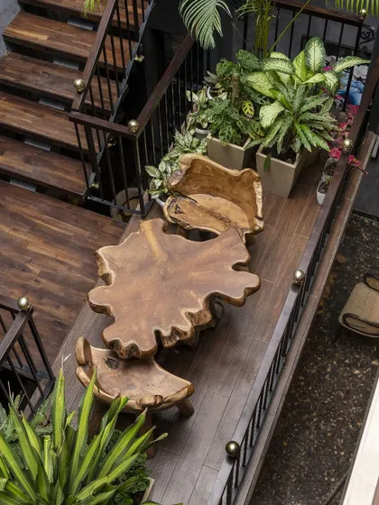 We believe transitional spaces should be as meaningful as destinations. On this staircase landing, we created a unique hanging garden with a live-edge wood table, transforming a simple passage into a serene nook for reflection and connection.