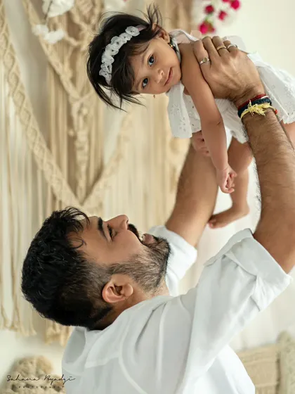 A duplicate of image 28, a father joyfully lifting his daughter. This dynamic and playful shot is always a favorite.