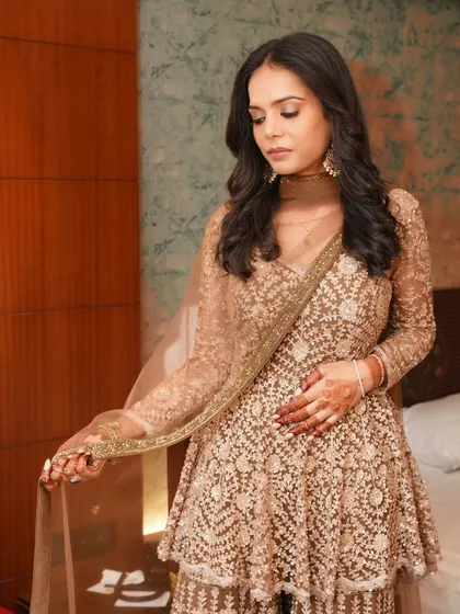 A full-length view of this matte glow look. The makeup is understated and elegant, allowing the intricate outfit to shine.