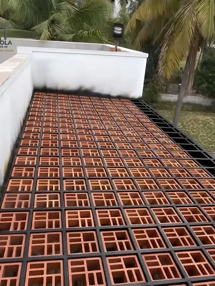 We constructed this rooftop pergola floor using a metal grid filled with terracotta jali blocks. This unique application allows for air circulation and drainage while creating a durable, patterned surface.