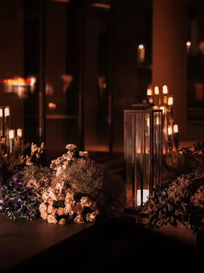 The entrance to the venue was styled with large, lush floral arrangements and candlelit lanterns. This created an enchanting welcome for guests, setting the stage for the elegant 50th birthday celebration that awaited them inside.