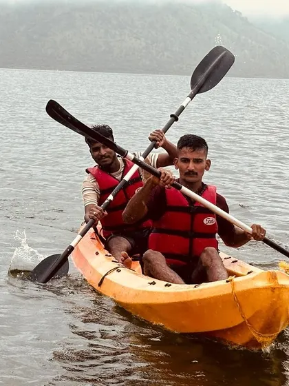 Two participants in a tandem kayak work together to power through the water, a great exercise in coordination.