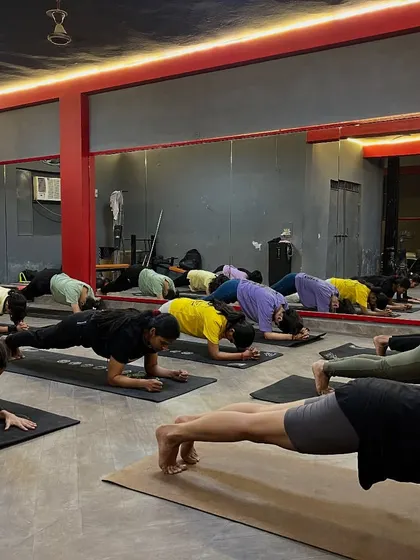Building core strength with a group plank pose. A strong core is essential for good posture and preventing back pain from sitting.