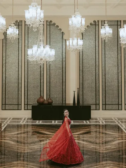 A portrait of regal elegance. We see every bride as royalty, and we take the time to compose shots that highlight her grace and the stunning details of her attire within the grandeur of the wedding venue.