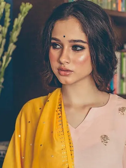 For this ethnic wear shoot, we designed a look with a dramatic winged eyeliner and luminous skin. The soft, textured waves in the hair add a modern touch to the traditional aesthetic.