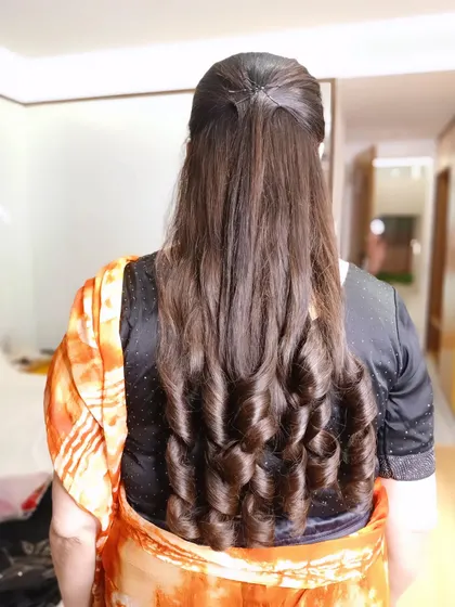 A simple yet elegant party hairstyle. I created these soft, bouncy curls for a client who wanted a glamorous look with her hair left open. This style is perfect for receptions or cocktail parties.