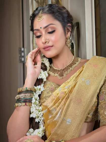 A soft and serene moment. The makeup is flawless, ensuring she looks perfect from every angle on her special day.