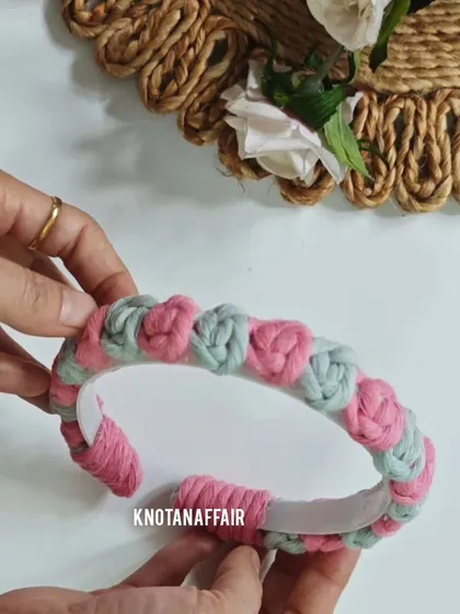 Another view of the pretty macrame rose flower hairband. The combination of pink and green is perfect for a fresh, floral look.