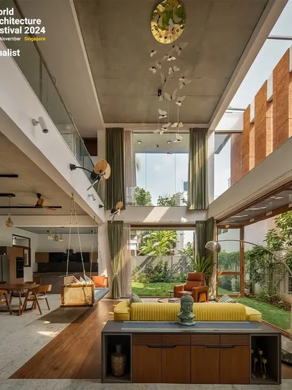 This is our "A Home by the Park" project, a finalist at the World Architecture Festival 2024. We designed this double-height living area to dissolve the boundaries between inside and out, using expansive windows and natural materials to create a constant connection with the garden.