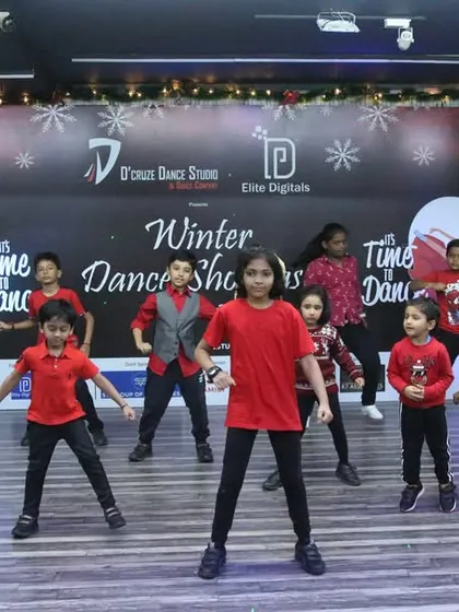 A full view of the kids' batch performance, filling the studio with energy.