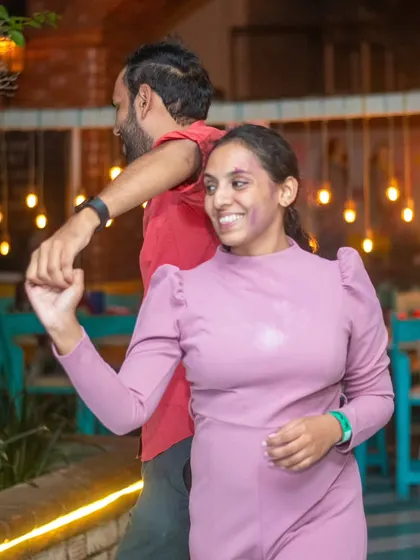 A beautiful smile, even with a splash of purple Holi color. Our themed nights bring out the playful side in everyone.