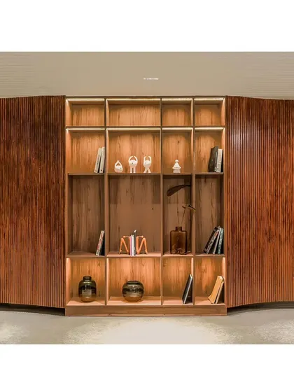 Here, a portion of the fluid wall opens up to reveal an integrated bookshelf, turning a simple corridor into a mini library and reading area for residents.