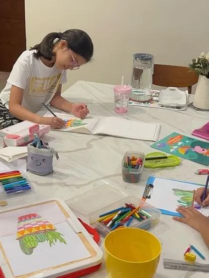 Art class is always better with best friends. These girls are working on their succulent-themed artwork in one of our cozy at-home group sessions.