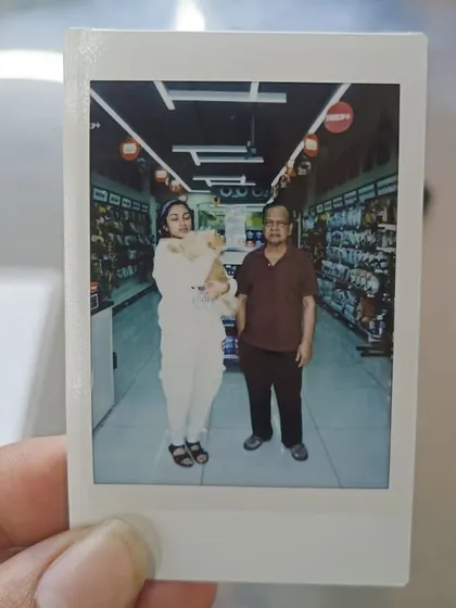 Another cherished polaroid memory from our Grooming Fest, showing a pet parent with her beautifully groomed dog.