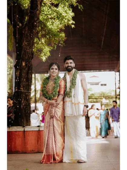 A classic full-length portrait of a couple at their temple wedding venue.