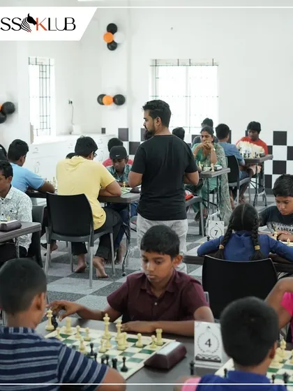 A wide shot of our Coimbatore center during the grand opening tournament, filled with young players engaged in intense matches.