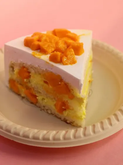 A close-up of our Mango Pastry slice, showing the layers of cake and fresh mango filling.