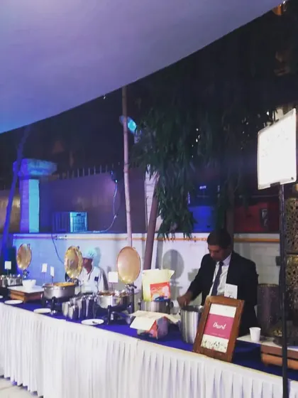 An evening buffet setup under a tent, with ambient lighting creating a warm and inviting atmosphere. This shows my capability in handling outdoor and nighttime events.