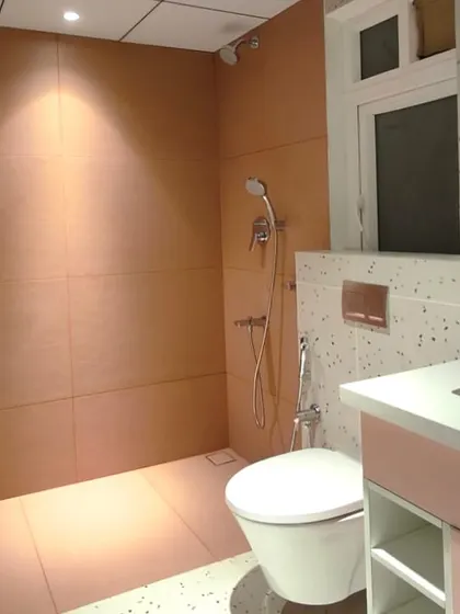 From a 3D render to reality. We brought this client's vision for a pink and terrazzo bathroom to life, focusing on every detail from the custom vanity to the warm, integrated lighting. This shows our commitment to executing a concept with precision.