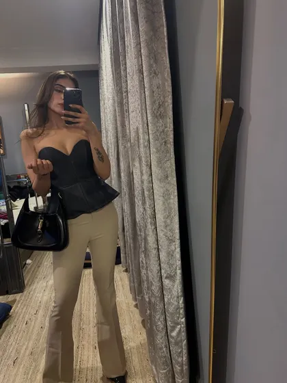 A mirror selfie from my "Magical March" dump, wearing a black corset top and beige pants.