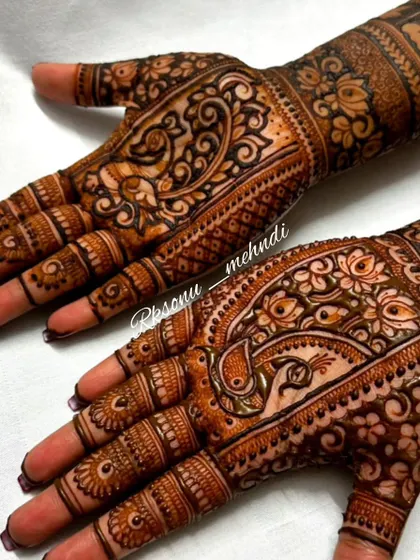 A beautiful design for a bride, featuring traditional peacock and paisley motifs. The intricate patterns and clean lines are perfect for a classic wedding look.