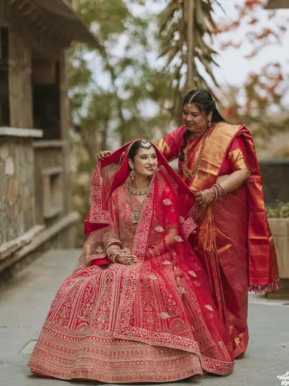 A touching moment between the bride and her mother, who helps adjust her veil before the ceremony.