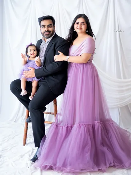 A formal family portrait with everyone dressed in beautiful shades of purple. Coordinating outfits can create a very polished and elegant look for your family photos.