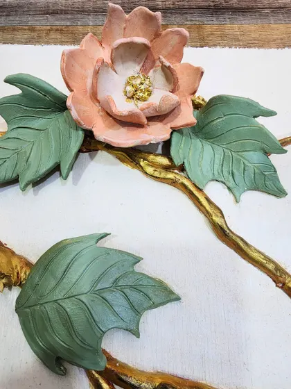 A close up of a sample flower with delicate, hand-sculpted petals and a textured center. These samples are a crucial part of my process, building a bridge between imagination and reality.