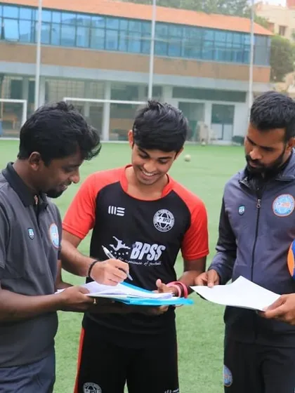 The official signing. Mayank Mahesh, flanked by our coaches, commits to his first A Division season.