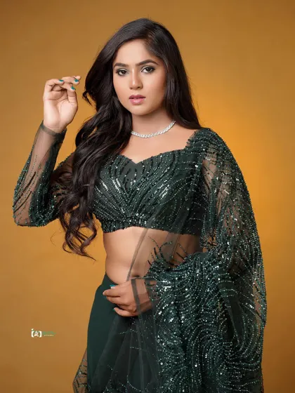 A strong and confident pose that showcases the modern design of this traditional lehenga. The direct gaze and pose make for a powerful fashion portrait.