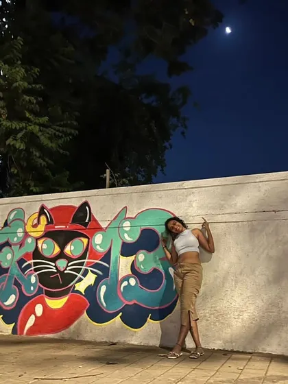 Under the moonlight with my finished cat graffiti. I love turning dull city walls into stories that make people stop and look.