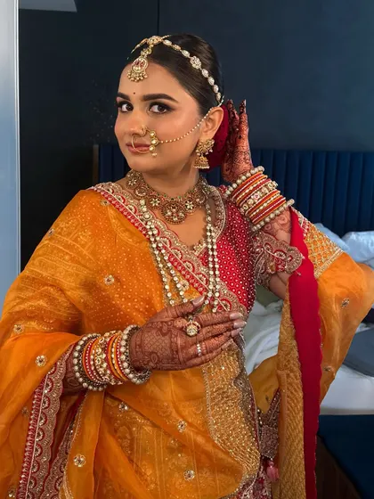 Adjusting her hair, this bride is all smiles. Her happiness is what makes the look truly complete.