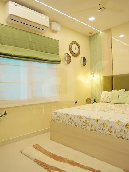 This bedroom combines soft green tones with floral patterns for a fresh and cheerful look. The design is simple yet elegant, creating a peaceful and inviting personal space.